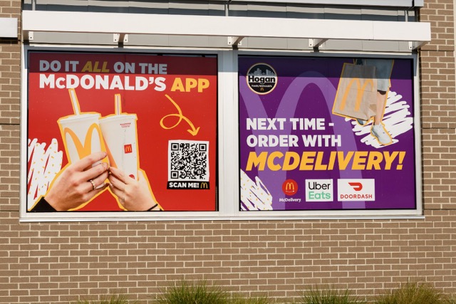 Window panels promoting the McDonald’s app and McDelivery through Uber Eats, DoorDash and Grubhub