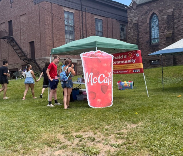 A large McCafé cup cutout and event tent set up at a community event